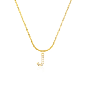 Macro detail of golden letter J pendant with shiny pavé cubic zirconia on snake chain