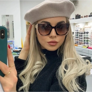 Fashionable tortoise shell sunglasses with gradient lenses shown in a mirror selfie style