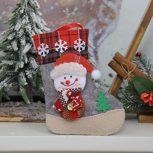 Detail of grey felt Christmas stocking with 3D snowman, tree applique, and red plaid cuff