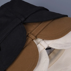 Detailed view of twill fabric texture and stitching on black, brown, and beige sun hats