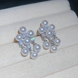 Detail view of Korean style pearl and zircon cluster ear clip on velvet jewelry box
