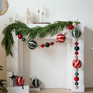 15cm festive painted Christmas ball ornaments in red, green, and silver on a white mantel
