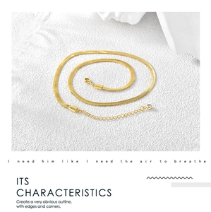 Detail of gold snake chain choker featuring lobster clasp and zircon pendant