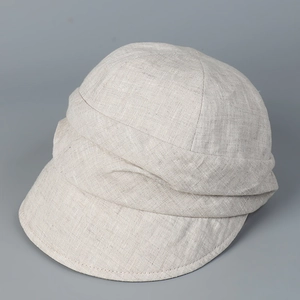 Close-up of pleated linen fabric texture and elegant layered design on sun hat
