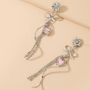 Elegant silver tassel earrings with pink heart crystals and sparkling bow details