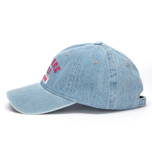 Detail of red New York embroidery and white label on light blue denim baseball cap