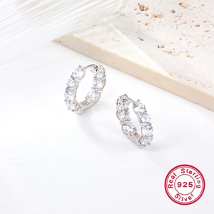 925 Sterling Silver hoop earrings featuring sparkling cubic zirconia on a stone surface
