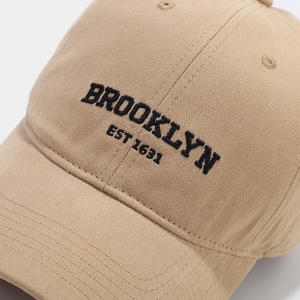 Detailed close-up of Brooklyn 3D embroidery and cotton twill texture on khaki baseball cap
