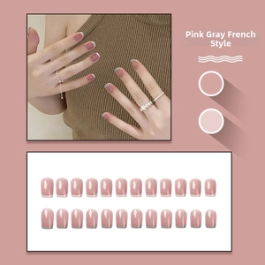 Close-up of pink and grey French style press-on nails with shiny finish and 24 pieces set