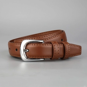 Close-up detail of a brown leather belt featuring a shiny silver metal buckle and dual loops.