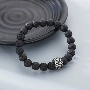 Close-up of black volcanic stone beads with a vintage silver-tone steel spacer bead