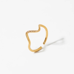 Gold wavy 316 stainless steel ring with micro-pave crystals on white background