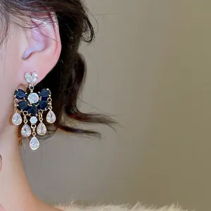 French palace style silver needle drop earrings with sparkling blue zircons and tassels