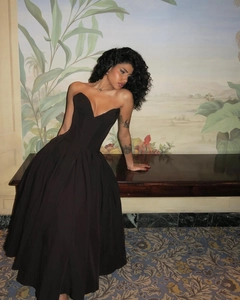 Detail of elegant black strapless corset maxi dress in a luxurious vintage interior setting