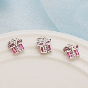 Set of three silver-plated gift box pendants with pink rectangular stones and tiny crystals