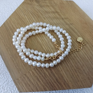 Detailed view of freshwater pearl necklace with gold lobster clasp and extension chain