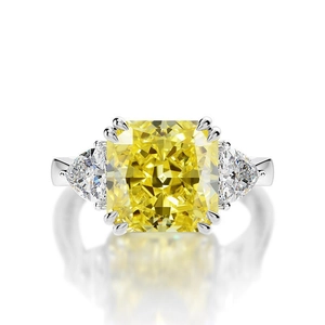 Macro detail of high-carbon yellow square diamond ring with triangular side stones