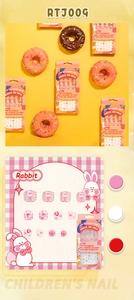 Detail view of cute pink rabbit press-on nails for kids in creative donut gift packaging
