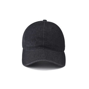 Detail of washed black vintage baseball cap showing fabric texture and curved brim