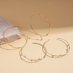 Irregular geometric hoop earrings with spiked studs in gold and silver finish