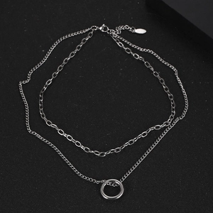 Double-layered silver stainless steel necklace with minimalist ring pendant on black background