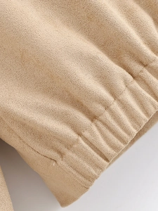 Detail of elastic gathered cuff on faux suede jacket with fine stitching in camel beige