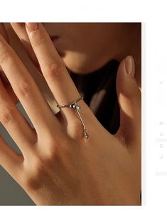 Detail of adjustable S925 sterling silver box chain ring with moissanite on finger