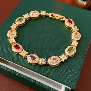 18K gold plated bracelet with colorful zircon stones on a green jewelry box