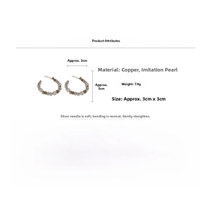Detailed view of C-shaped earrings with faux pearls and golden beads on silver posts