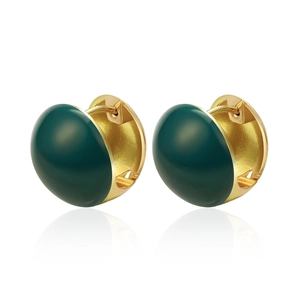 Close-up of vintage gold alloy earrings with deep green enamel semi-sphere detail
