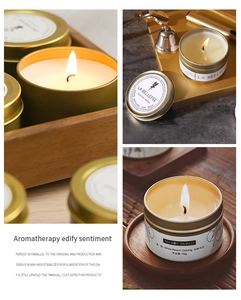 Detail of White Peach Oolong soy wax candle in gold tin with lit wick close-up