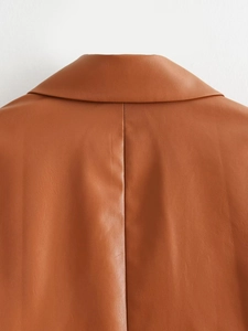 Close-up of the stitching details on the back collar of a brown PU leather blazer