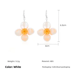 Detail view of peach orange citrus fruit petal earrings with 6.3cm size dimensions