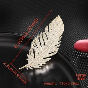 Detailed view of large feather brooch with dimensions 6.1cm by 2.3cm and cubic zirconia