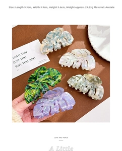 Detail showing leaf-shaped acetate hair claws in various marble textures and sizes