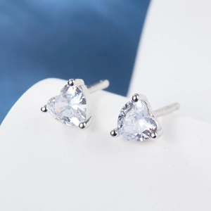 Macro detail of heart-cut cubic zirconia earrings with 925 silver three-prong setting