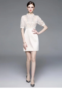Detail of high-neck lace patchwork dress with beaded sequins and satin skirt