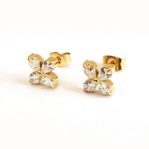 Detailed macro view of 18k gold-plated four-leaf clover stud earrings with zircon stones