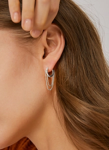 Detail of silver hoop earrings with tassel chains and micro-pave cubic zirconia stones