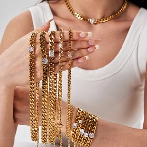 Close-up of 18K gold plated Cuban link necklaces and bracelets with inlaid cubic zirconia
