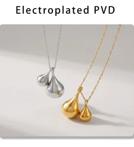 Detail of PVD gold and silver teardrop pendants with polished metallic finish