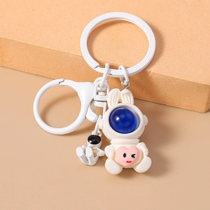 Cute white astronaut bunny keychain with mini figure and pink heart charm accessory