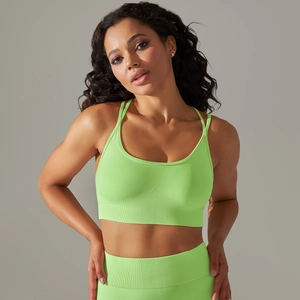 Close-up of neon green ribbed knit fabric on seamless supportive sports bra and leggings