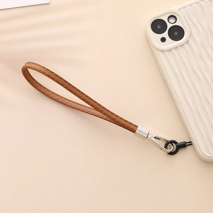 Brown PU leather phone wrist strap with double stitching and metal clasp on white case