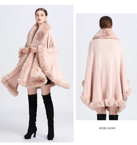 Detailed model view of a pink knit poncho cardigan featuring a plush faux fur collar and hem