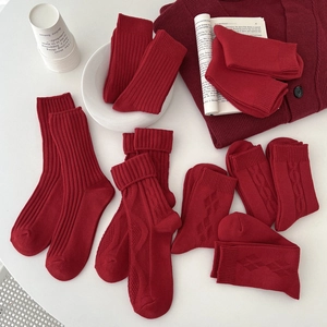 Red cotton crew socks with various knit textures including ribbed and cable patterns