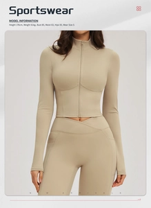 Front view of slim-fit beige yoga jacket and crossover leggings with size info
