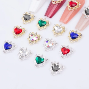 Hollow alloy heart nail art charms with colorful rhinestones on a white background