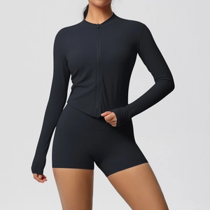Detail of black yoga set featuring thumbholes on sleeves and a slim-fit zipper jacket