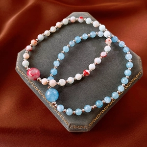 Detail view of Shoushan stone beaded bracelets with blue and red marble textures